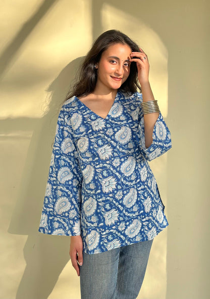 A woman wearing a blue floral cotton  kurti